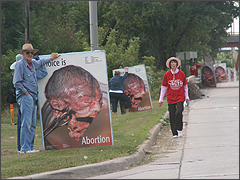 Volunteers hold third trimester abortion signs in Elmhurst, IL