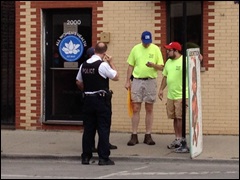 PLAL staffers Matt Yonke (right) and Eric Scheidler talk with police outside All Women's Health abortion clinic in Chicago
