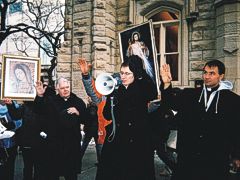 Fr. Paul Stein leads prayers at Water Tower