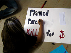 Student works on a pro-life picket sign during a workshop in Groom, TX