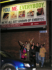 Eric beneath a Youth Defence billboard