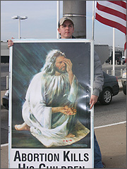 Volunteer Chris Iverson with a Jesus sign