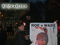 Luann Bloom holds a Malachi sign outside the Ritz