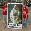 Scheidler girls hold a Jesus sign