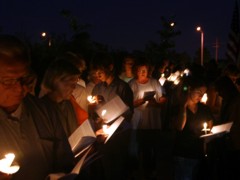 The faithful gather at the candlelight vigil.