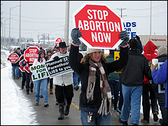 Protesters march outside of Planned Parenthood Aurora