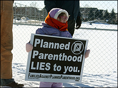 Little girl with a 'Planned Parenthood Lies to You' sign at a monthly protest.