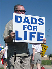 Man holding Dads for Life sign
