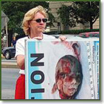 Pro-lifer holds a graphic abortion sign in Washington DC