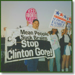 Protesters hold signs opposing Clinton and Gore