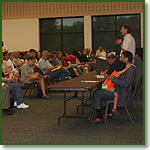 Eric Scheidler addresses a community meeting in Aurora, Illinois