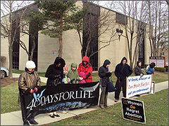 Pro-lifers pray in front of Goyal's new location. [Photos by Dan Gura]