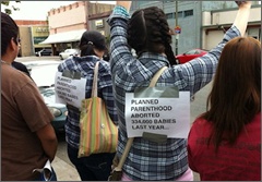 Pro-life teens protesting in front of Planned Parenthood booth at Street Fair in Dixon, CA [Photo via Live Action]