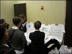 Attendees check out entries in TeenSpeak's Pro-Life T-Shirt Design Workshop